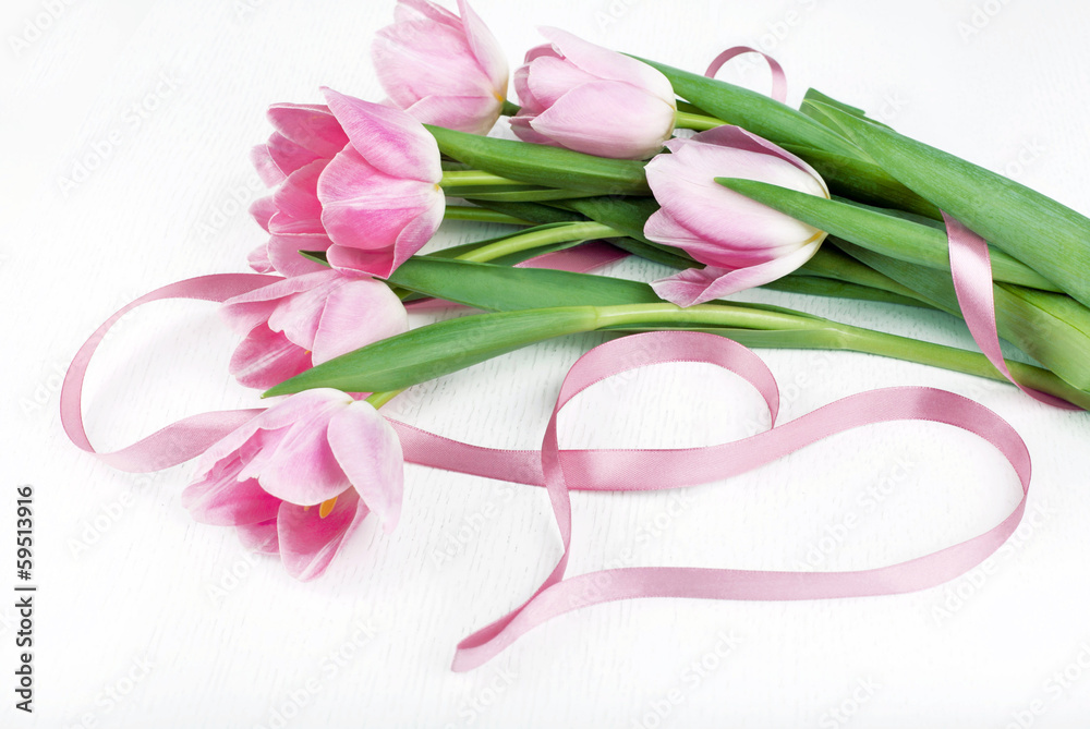 Beautiful bouquet of pink tulips and pink ribbon , isolated on w