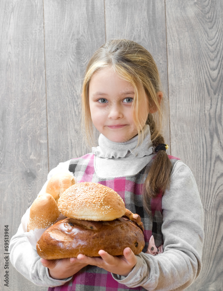 girl holding a lot of bread girl holding a lot of bread