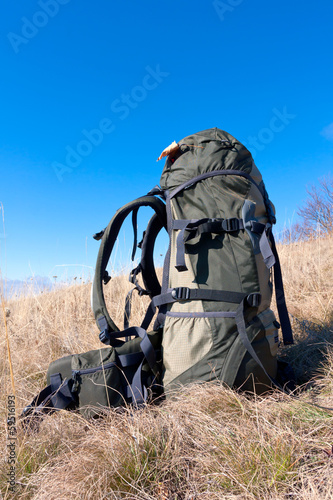 backpack on field in mountains