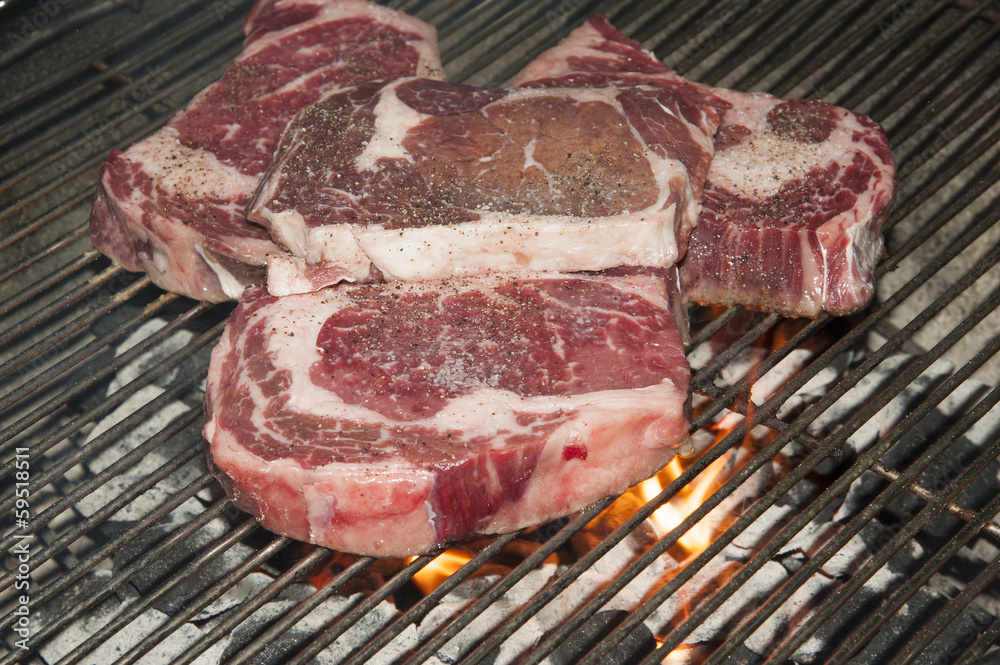 Ribeye steaks on a barbecue Ribeye steaks on a barbecue