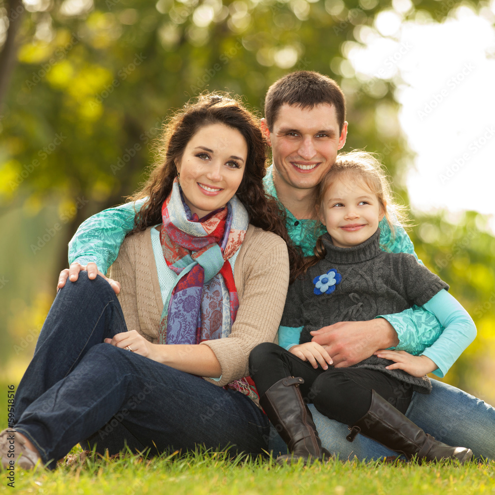 Happy family, mother, father and daughter in the park Happy family, mother, father and daughter in the park