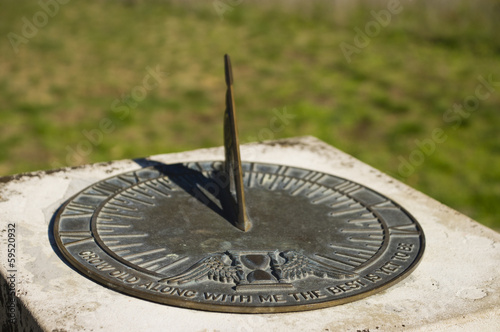 Bronze sundial with inscription and shadow