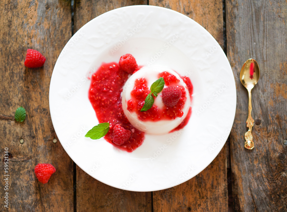 Delicious italian dessert panna cotta with raspberry sauce and m Delicious italian dessert panna cotta with raspberry sauce and m