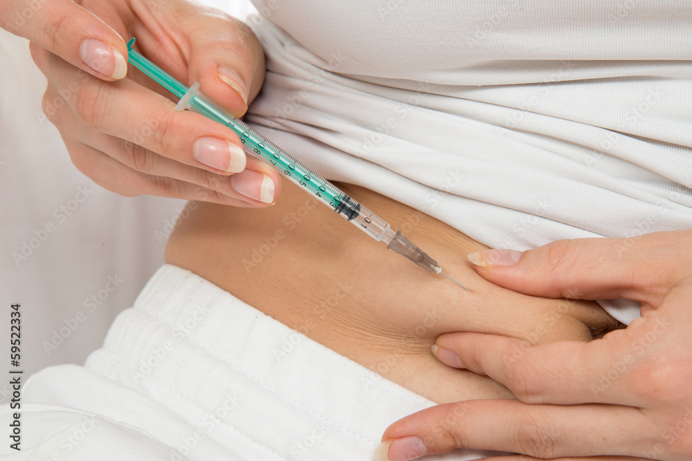 Doctor making diabetes patient insulin shot by syringe Doctor making diabetes patient insulin shot by syringe