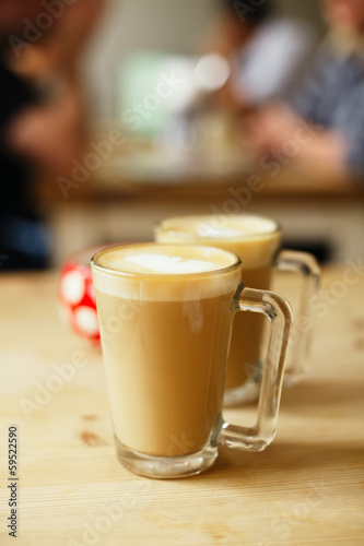 coffee latte in two tall glasses and sugar bowl, shallow dof