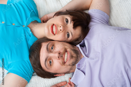 Relaxing couple lying in bed
