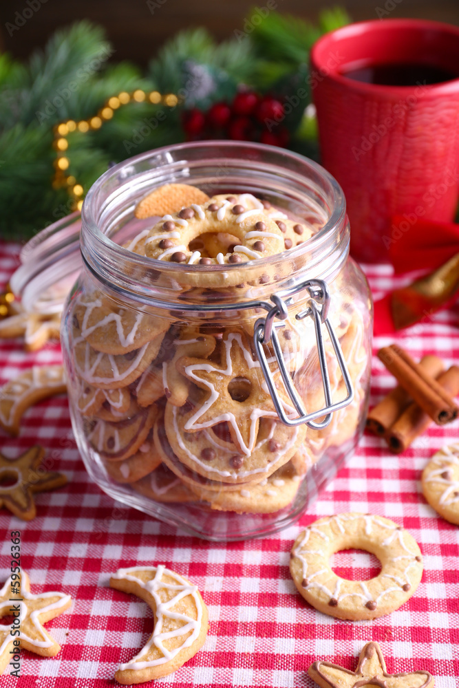 Delicious Christmas cookies in jar on table close-up Delicious Christmas cookies in jar on table close-up