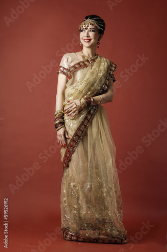 beautiful female wearing traditional indian costume posing
