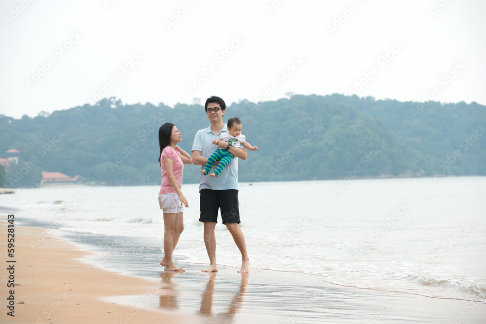 Portrait Of asian Family walking On the Beach