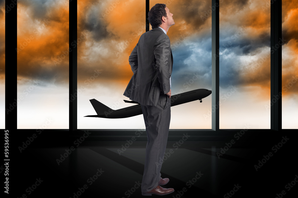 Composite image of serious businessman with hands on hips Composite image of serious businessman with hands on hips