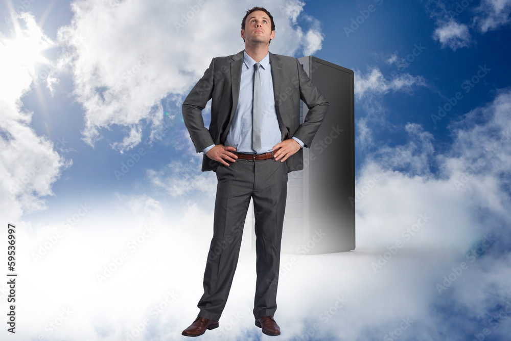 Composite image of serious businessman with hands on hips Composite image of serious businessman with hands on hips