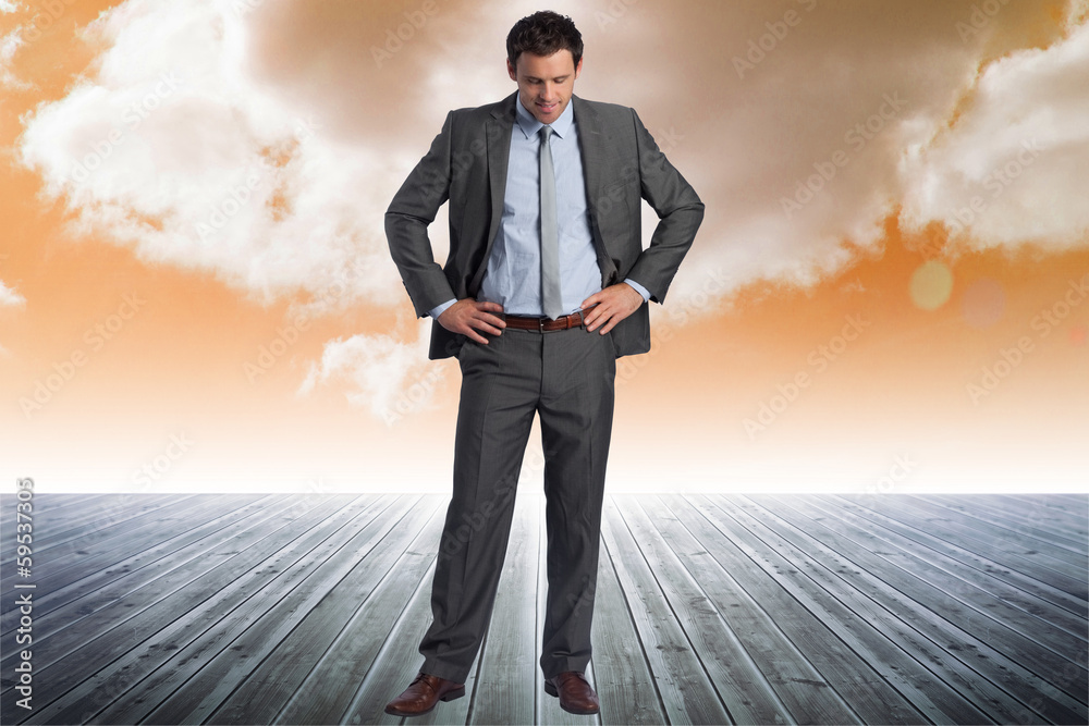 Composite image of smiling businessman with hands on hips Composite image of smiling businessman with hands on hips