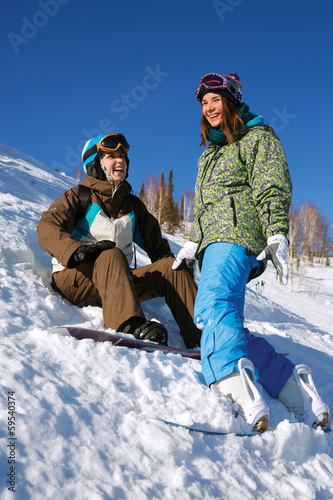 Two cheerful snowboarders