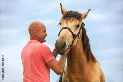 a man walks with his horse