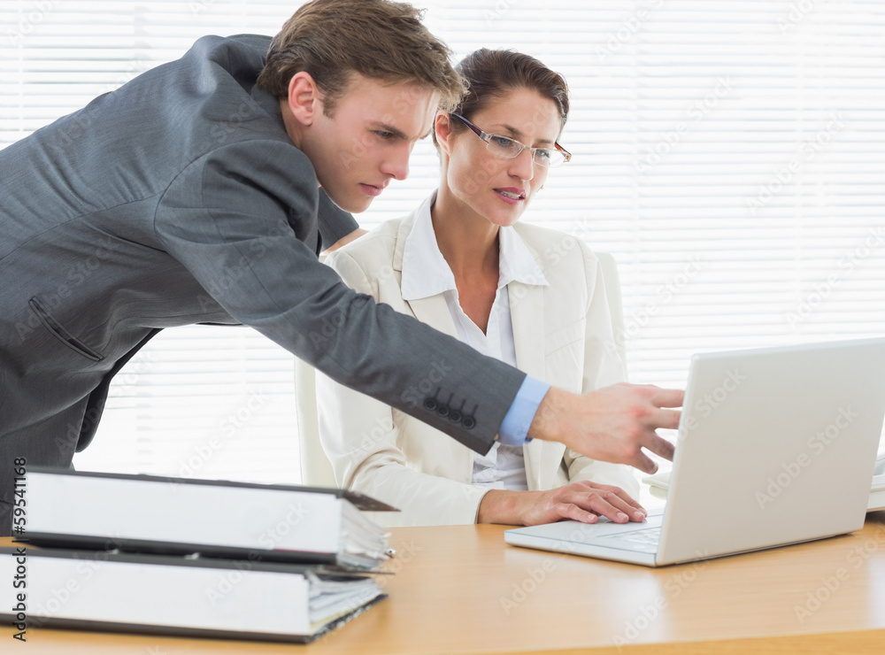 Concentrated business couple using laptop Concentrated business couple using laptop