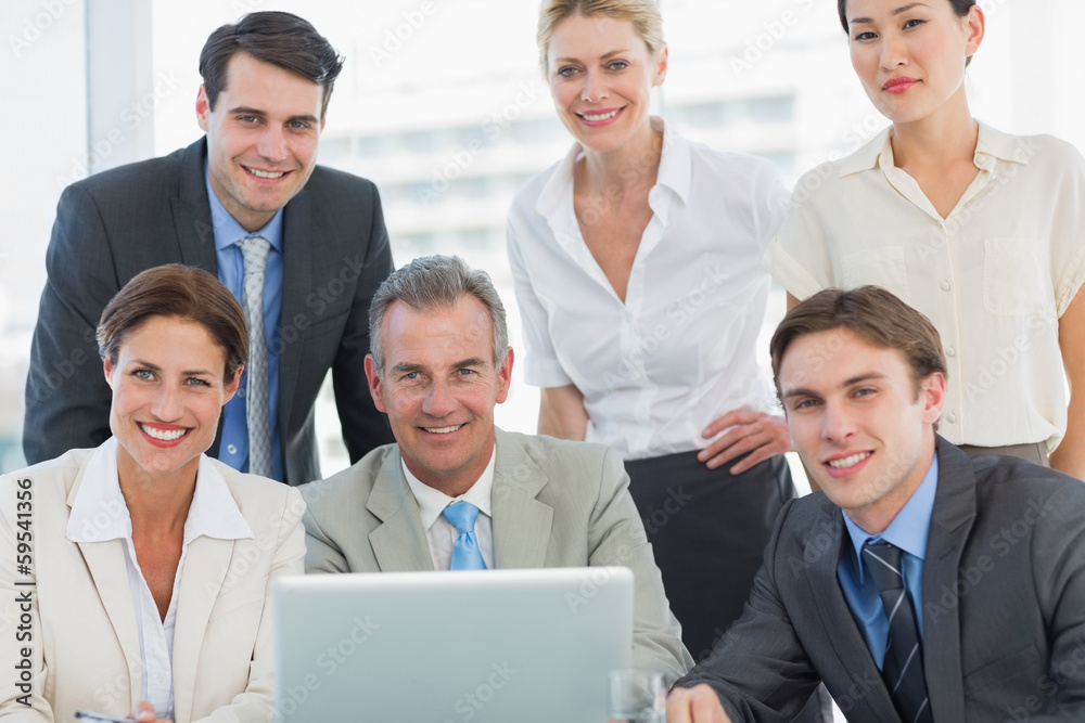 Business colleagues with laptop at office desk Business colleagues with laptop at office desk