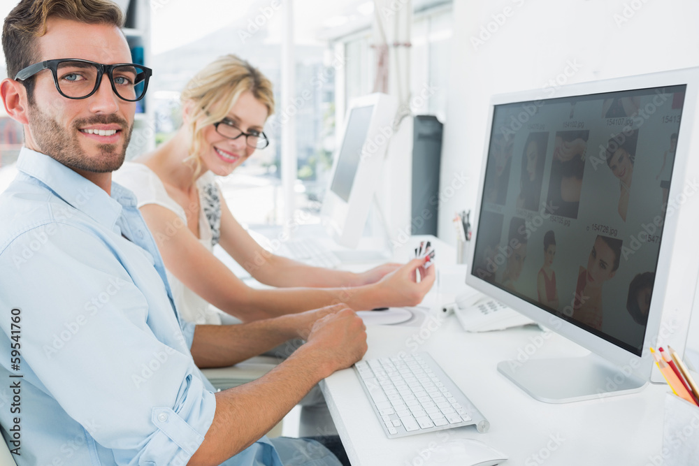 Smiling casual young couple working on computer Smiling casual young couple working on computer