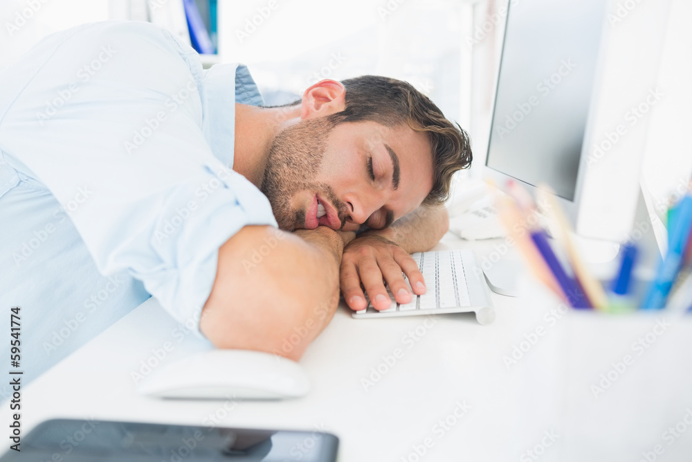 Male artist with head resting on keyboard Male artist with head resting on keyboard