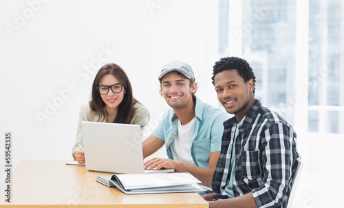 Artists working at desk in creative office