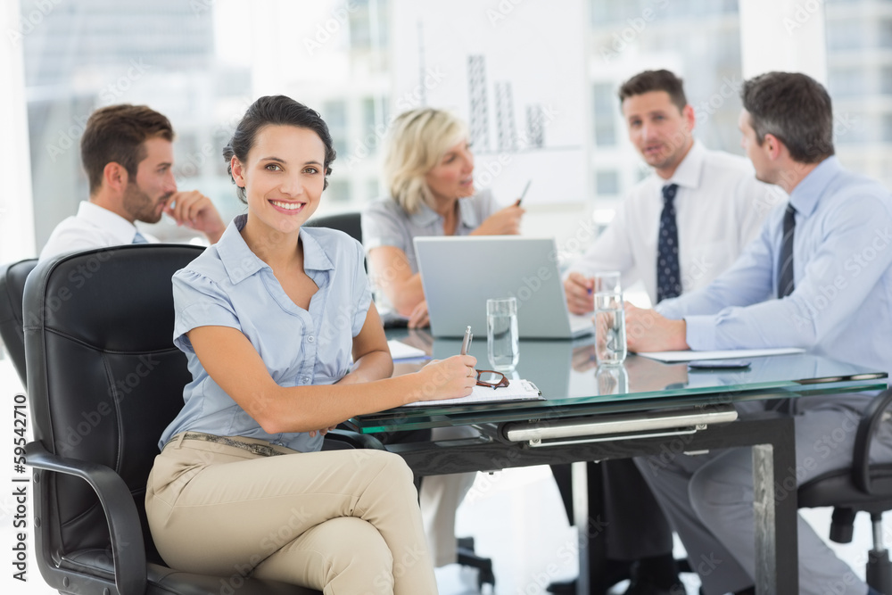 Young businesswoman with colleagues discussing in office Young businesswoman with colleagues discussing in office