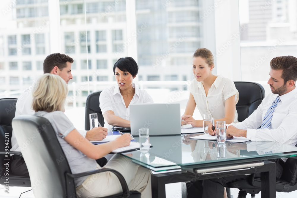 Well dressed business people in discussion at office Well dressed business people in discussion at office