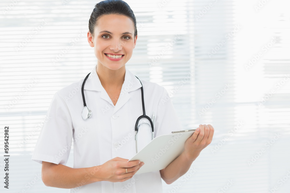 Portrait of a beautiful young female doctor with clipboard Portrait of a beautiful young female doctor with clipboard