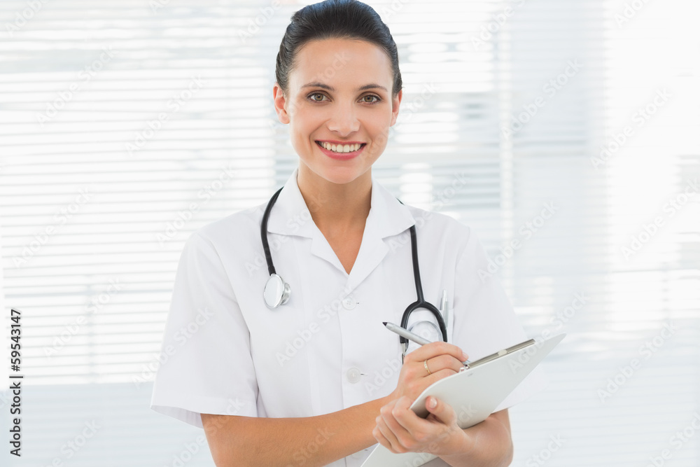 Portrait of a beautiful young female doctor with clipboard Portrait of a beautiful young female doctor with clipboard