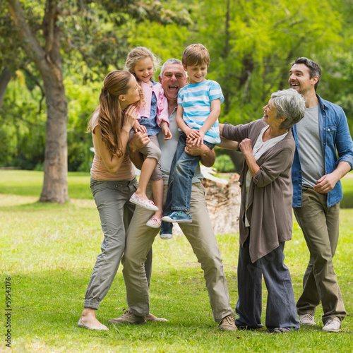 Extended family playing in park