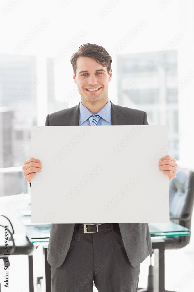 Handsome smiling businessman holding placard