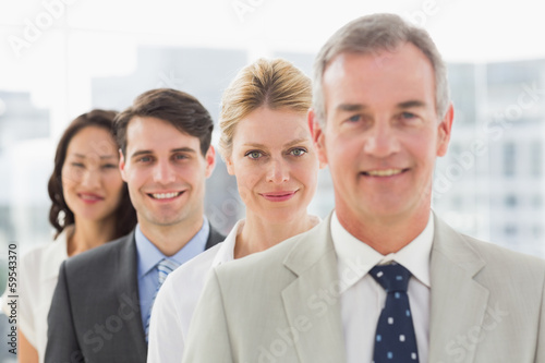 Cheerful business team standing in a line