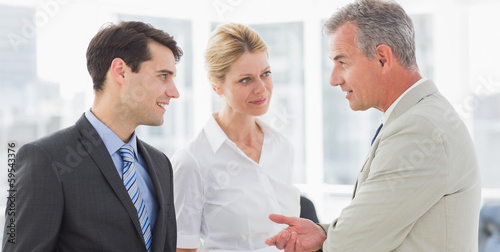 Smiling business team talking together