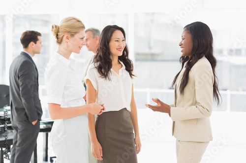 Businesswomen speaking together in conference room