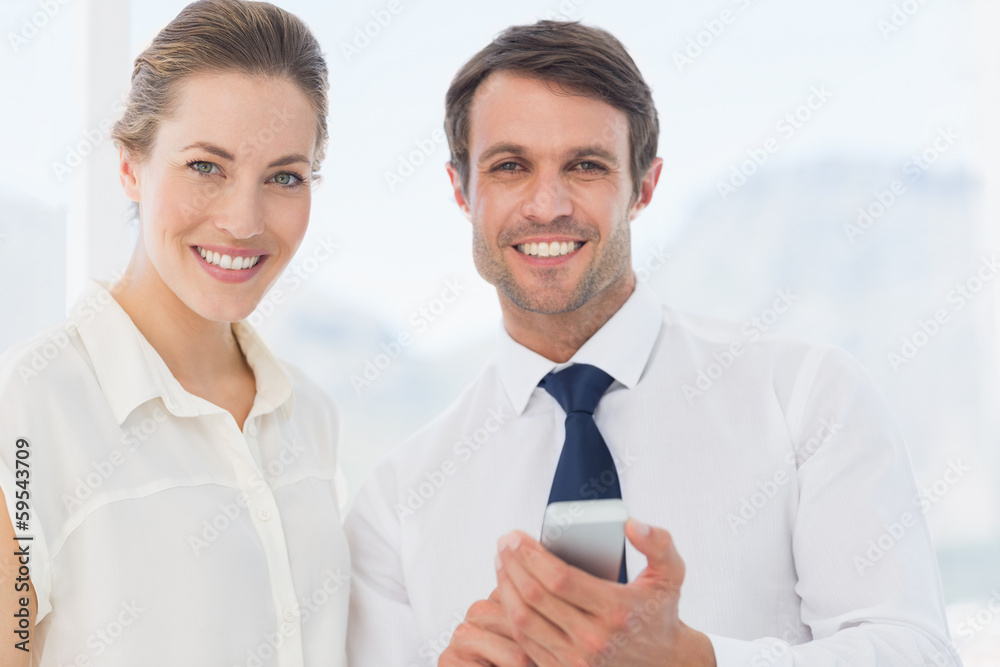 Smartly dressed colleagues with a mobile phone Smartly dressed colleagues with a mobile phone