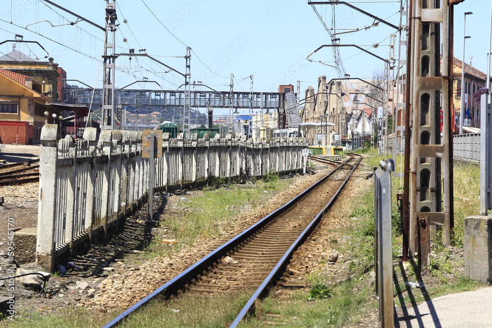 rail train entering a station, with many utility poles rail train entering a station, with many utility poles