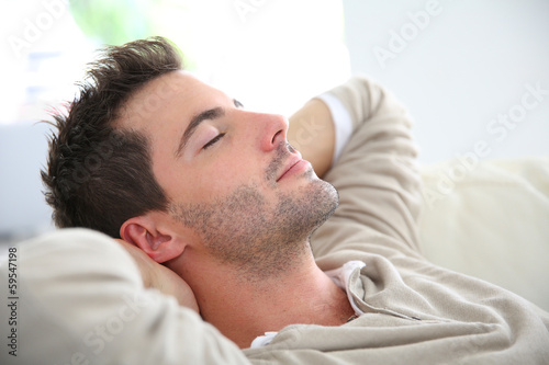 Man taking a nap in sofa photo