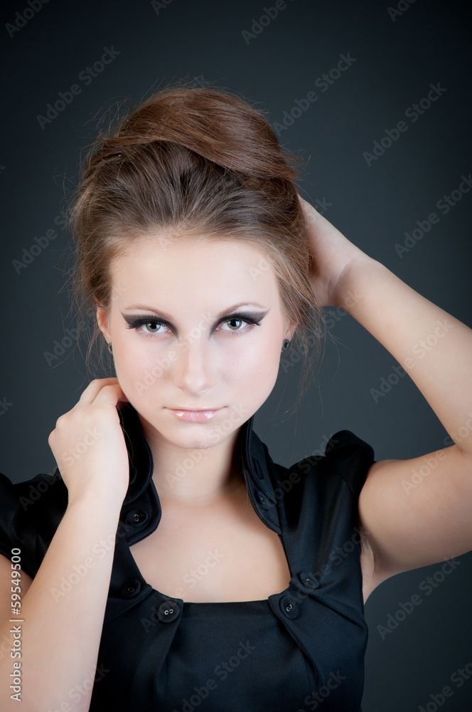 Fototapeta premium Young attractive fashion model posing on dark background.