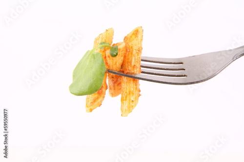 Pesto rosso decorated with cress on a fork