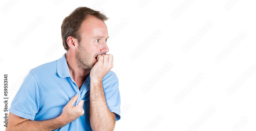 Stressed young man biting his fingernails, looking anxious Stressed young man biting his fingernails, looking anxious