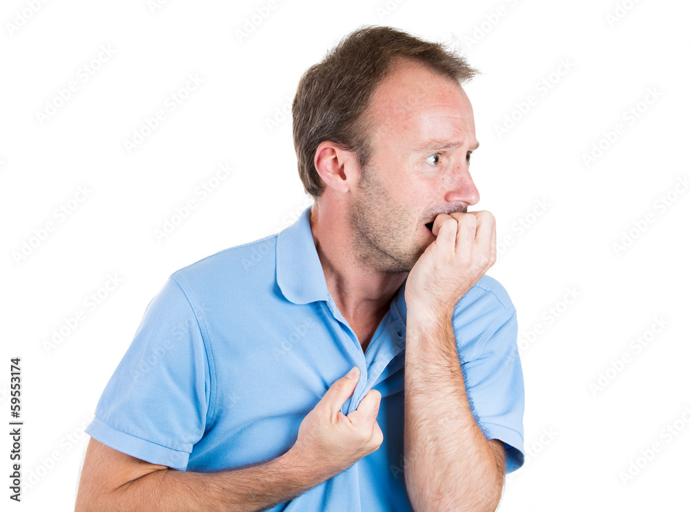 Stressed young man biting his fingernails, looking anxious Stressed young man biting his fingernails, looking anxious