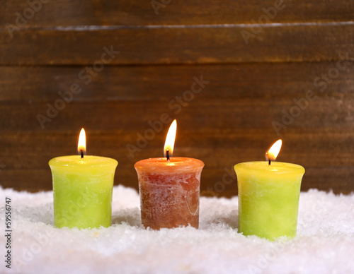 Burning candles on wooden background