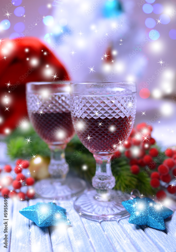 Obraz premium Wine glasses and Christmas decorations on bright background