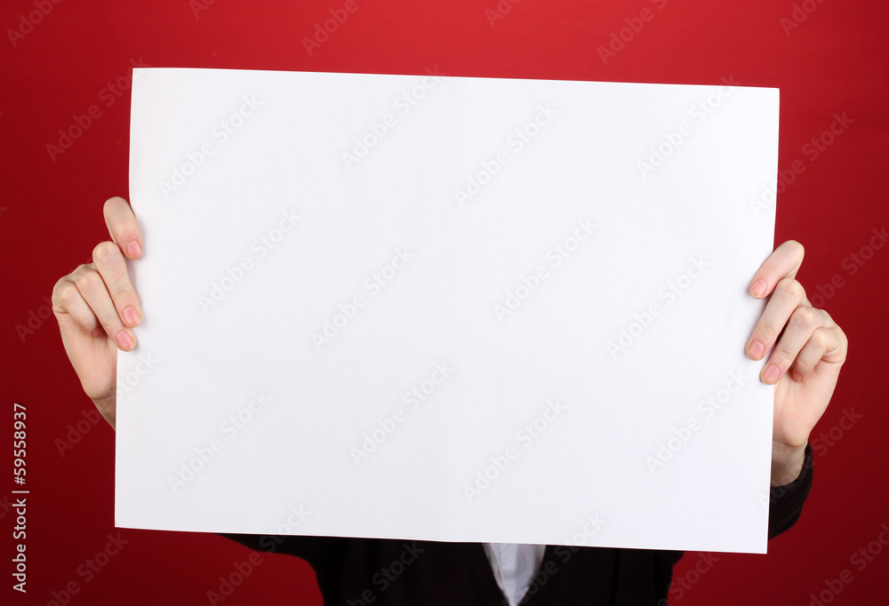 Woman holding blank sign in front her face, on color background Woman holding blank sign in front her face, on color background