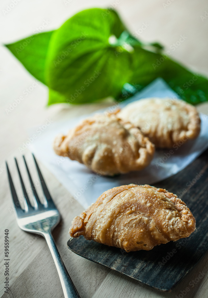 Snack of curry puffs on dish