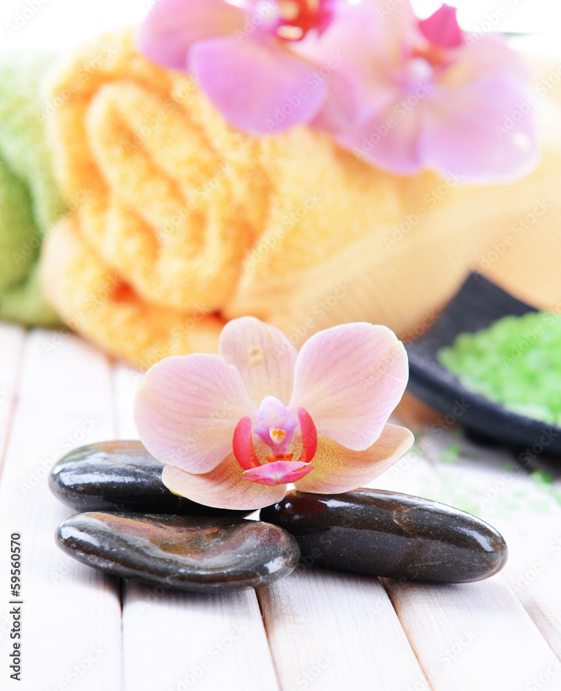 Still life with beautiful blooming orchid flower, towels and Still life with beautiful blooming orchid flower, towels and