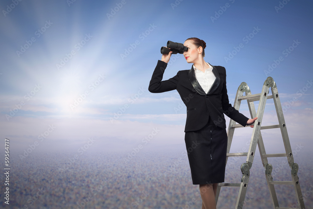 Obraz premium businesswoman looking through binoculars