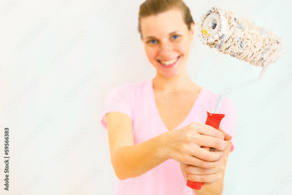 Young Happy Woman with roller brush. Young Happy Woman with roller brush.