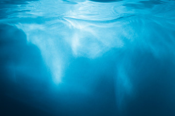 Abstract blue background. Water with sunbeams