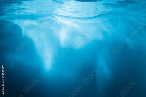 Abstract blue background. Water with sunbeams