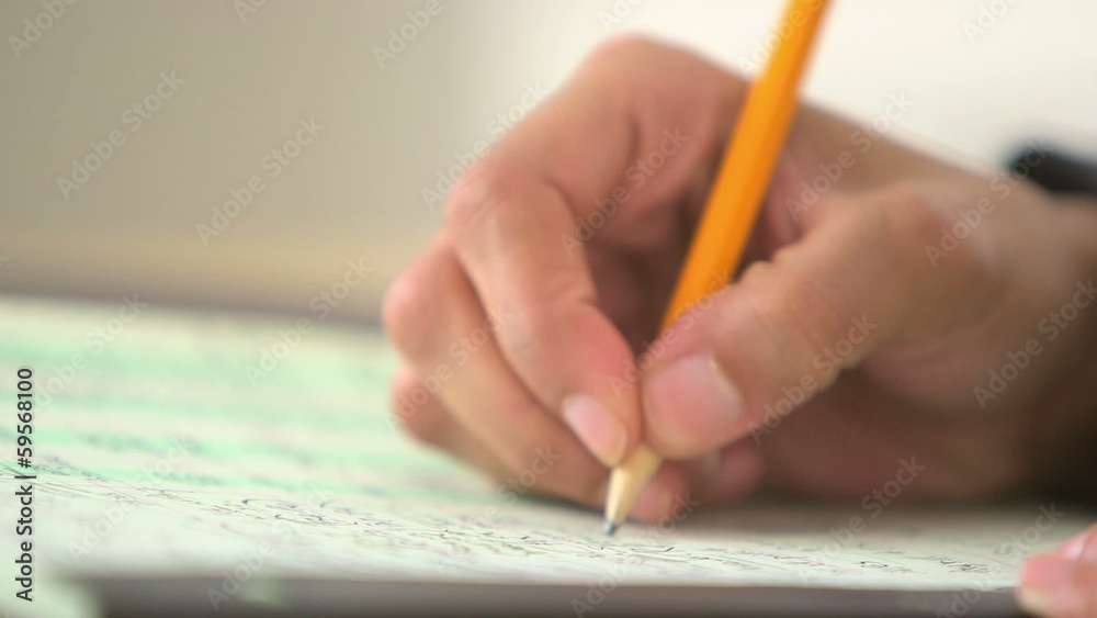 Close up of business woman writing with pencil