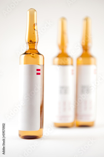 Brown injection ampule on blur background